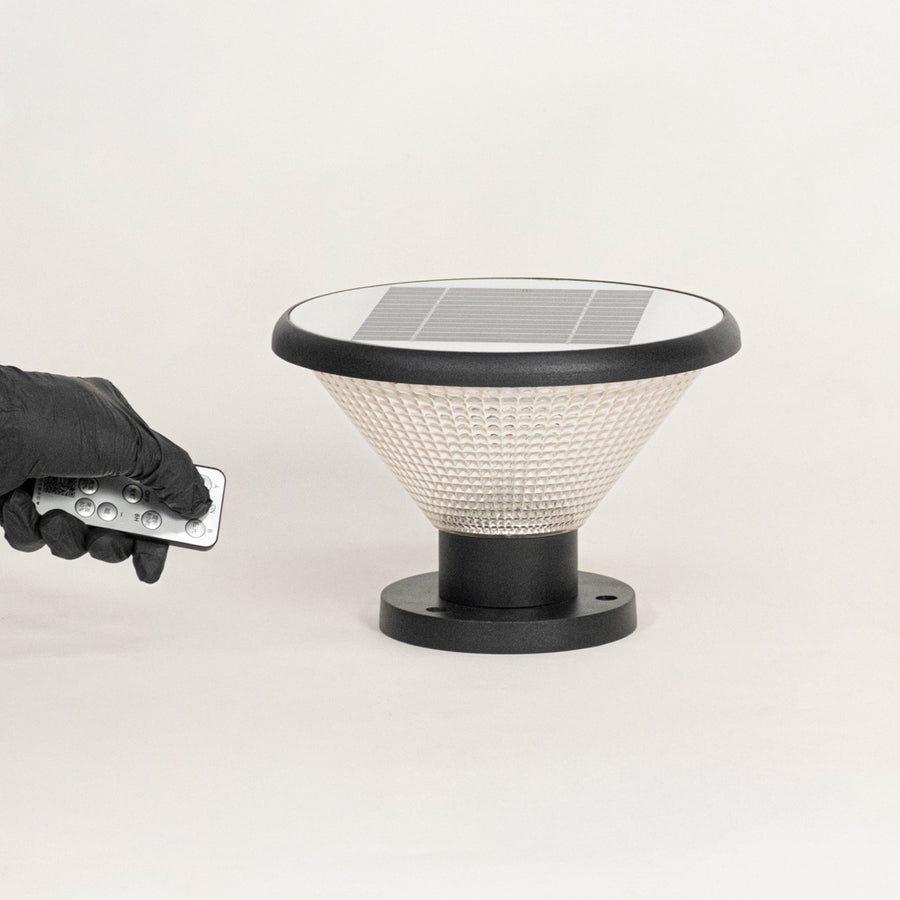 Black solar outdoor gate light with remote control for smart exterior lighting and decor use.