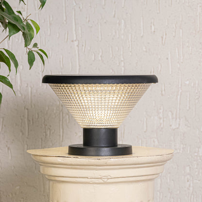 Black solar outdoor gate light with warm glow styled beside plants for elegant exterior decor ambiance.