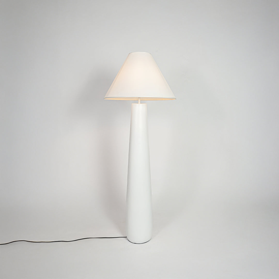 Stylish table lamp with white fabric shade and sleek base placed in modern living room setting ideal for soft decorative lighting.

