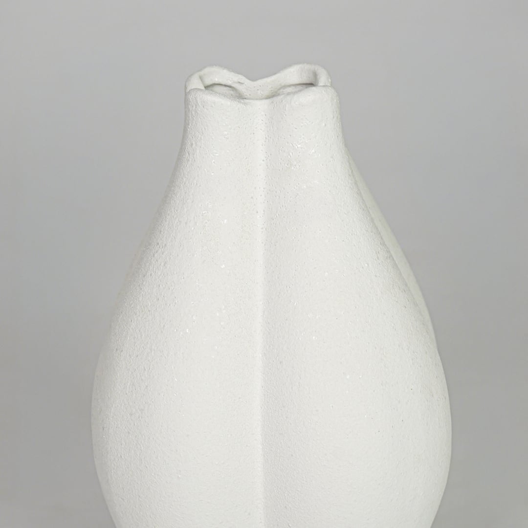 Closeup white smooth ceramic vase texture detail modern decorative flower vase for table shelf console decor.