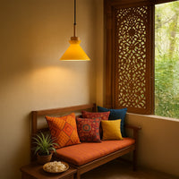 Yellow metal pendant light above daybed adding Scandinavian charm and warm ambient lighting to cozy interiors.