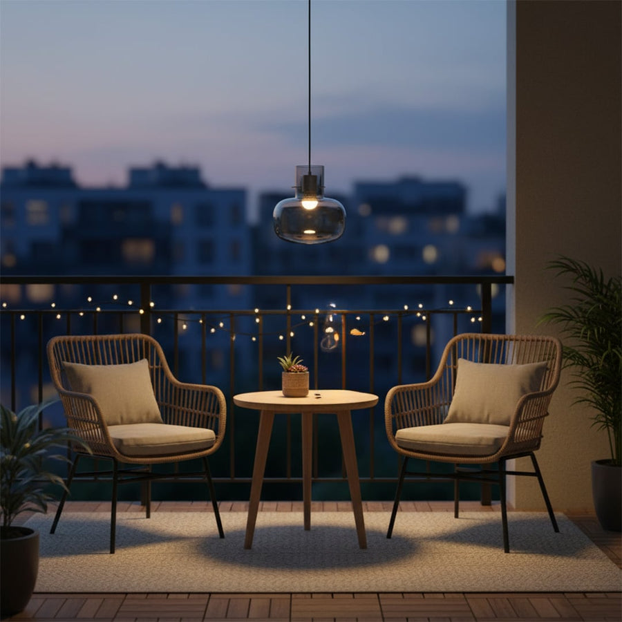 Glass pendant light glowing softly above balcony seating adding cozy ambient lighting and refined elegance to outdoor evening decor.