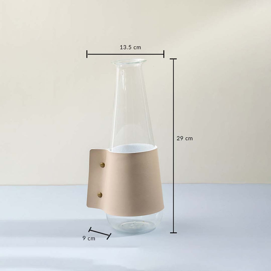 Dimension image of tapered clear glass carafe vase with beige leather wrap sleeve showing 29 cm height and 13.5 cm width.