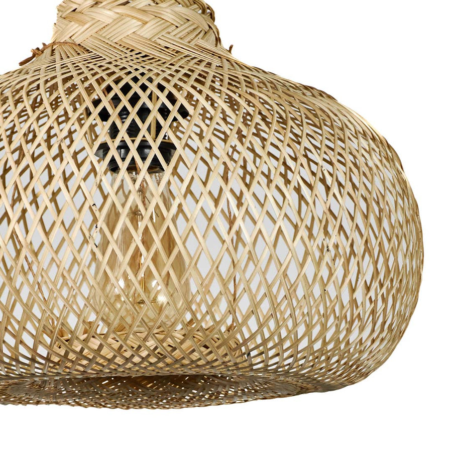 Large rattan pendant light with organic rounded shape and airy woven texture suspended against minimal neutral wall background for modern boho interiors.

