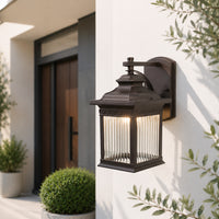 Black metal outdoor wall light with clear glass for porch entrance garden and exterior walls with warm ambient lighting.