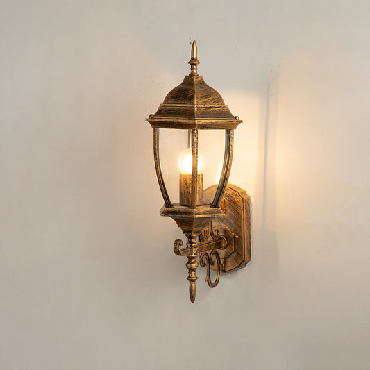 Vintage bronze outdoor wall light on white background with clear glass shade for classic exterior decor.