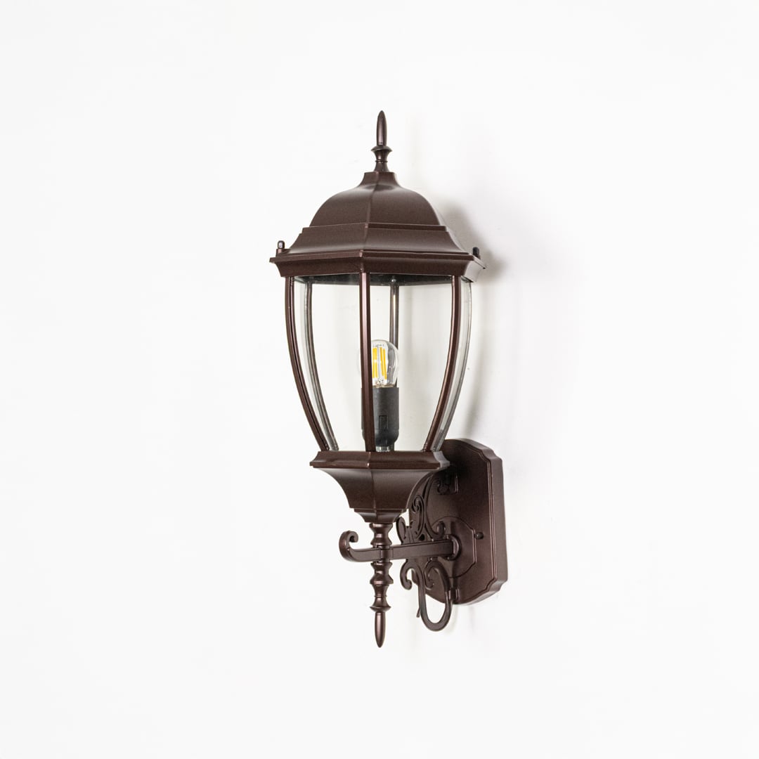 Outdoor wall lantern light off on white background displaying metal body glass panels and detailed classic structure.