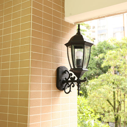 Classic black outdoor wall lantern mounted on tiled exterior wall near balcony area adding elegant daylight presence and traditional charm to home exterior lighting.