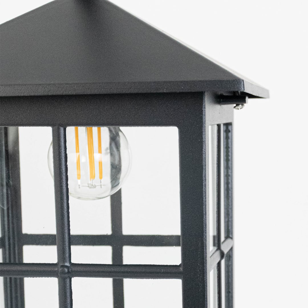 Detailed view of black lantern light highlighting pyramid top and clear glass sides.