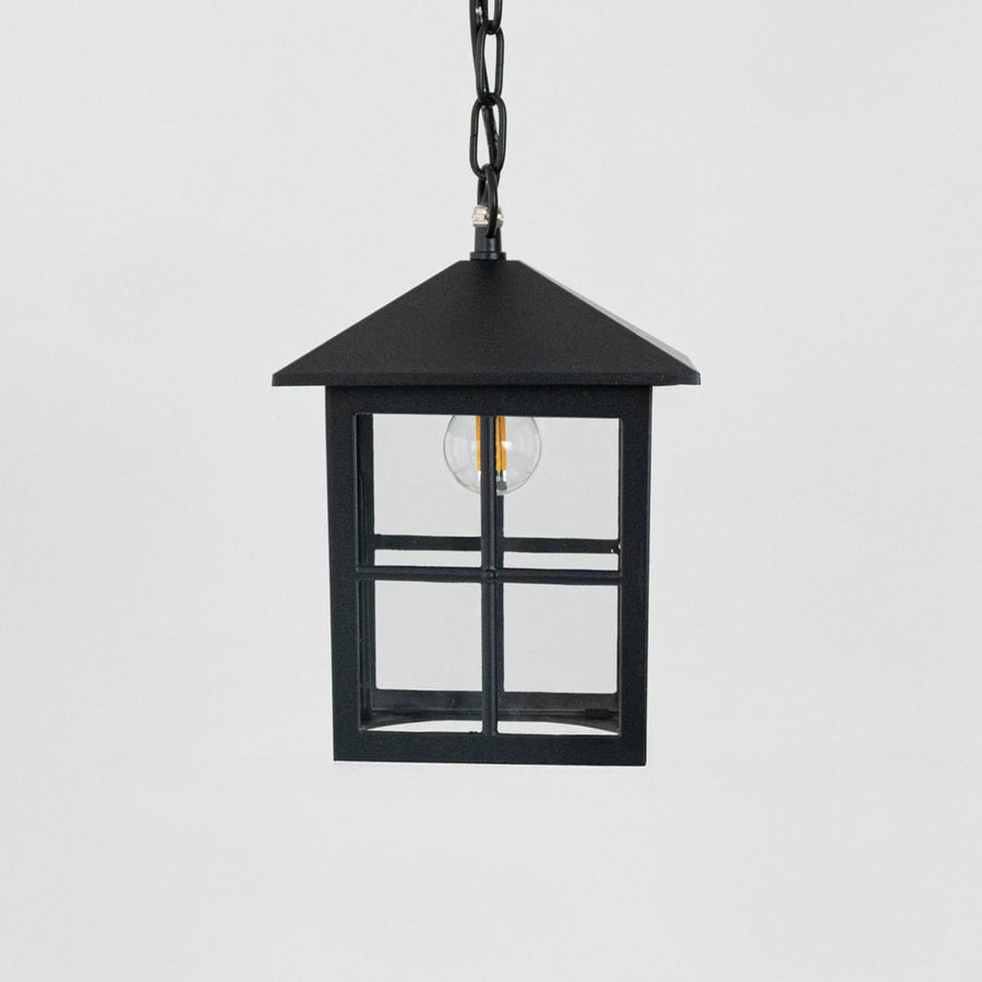 Black hanging lantern light turned off on white background showing clean lines and classic finish.