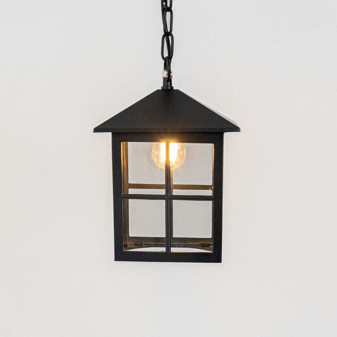 Elegant black metal box hanging lantern light with clear glass panels for modern outdoor lighting decor.