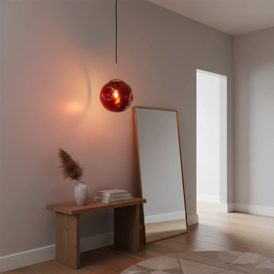 Amber glass pendant light with black metal accents enhancing entryway decor with inviting ambient light.
