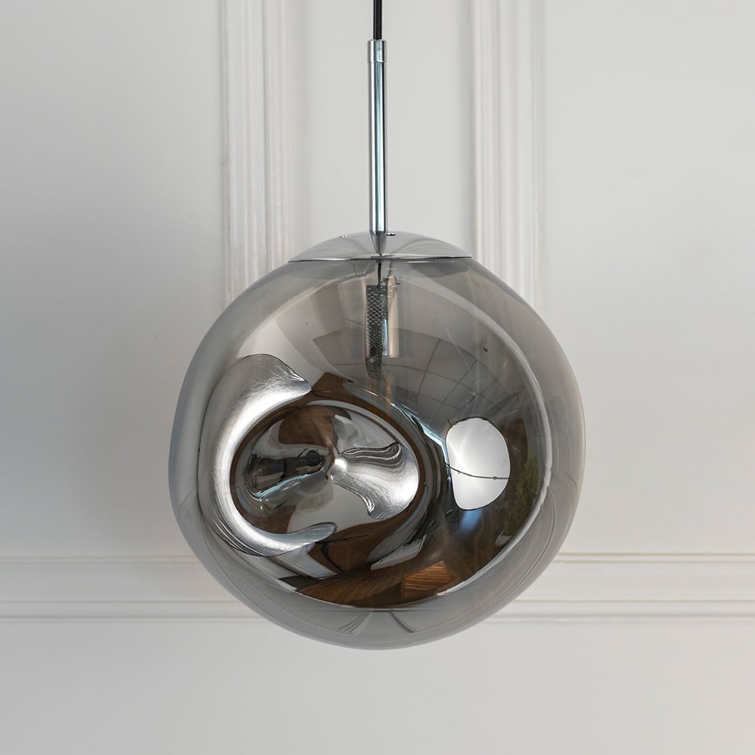 Closeup of smoky glass pendant light with metallic finish showcasing artistic curves and premium details.