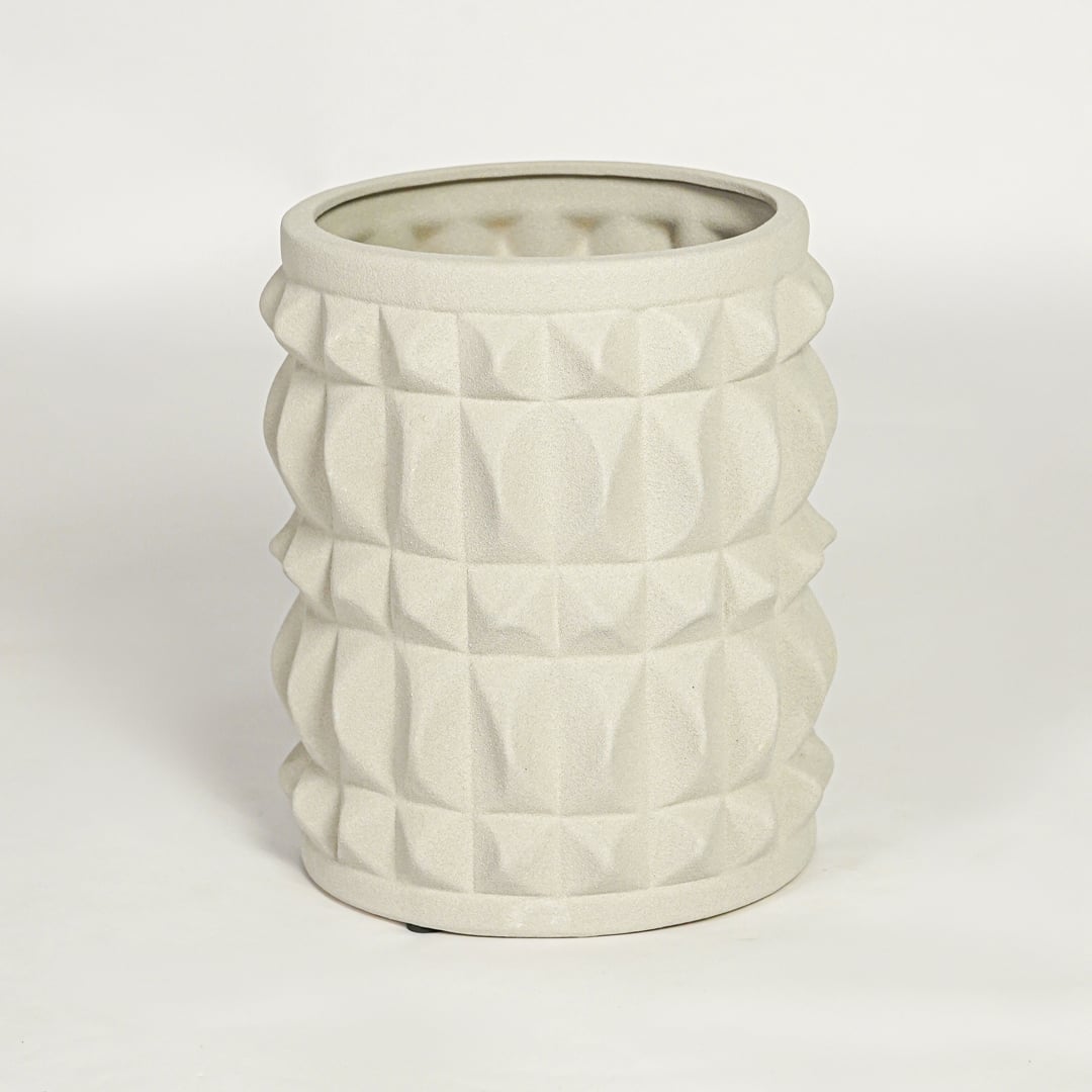 Modern light beige ceramic statement planter with embossed pattern for coffee table console or shelf styling.