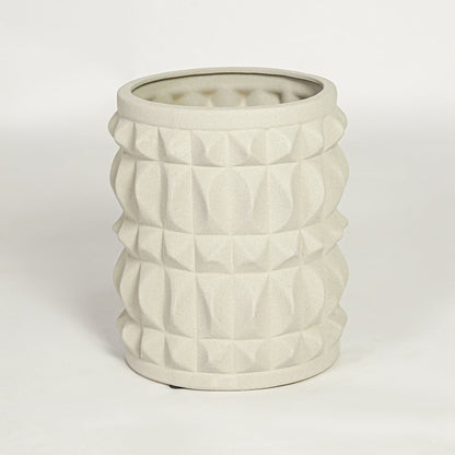 Modern light beige ceramic statement planter with embossed pattern for coffee table console or shelf styling.