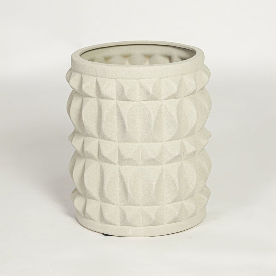 Modern light beige ceramic statement planter with embossed pattern for coffee table console or shelf styling.