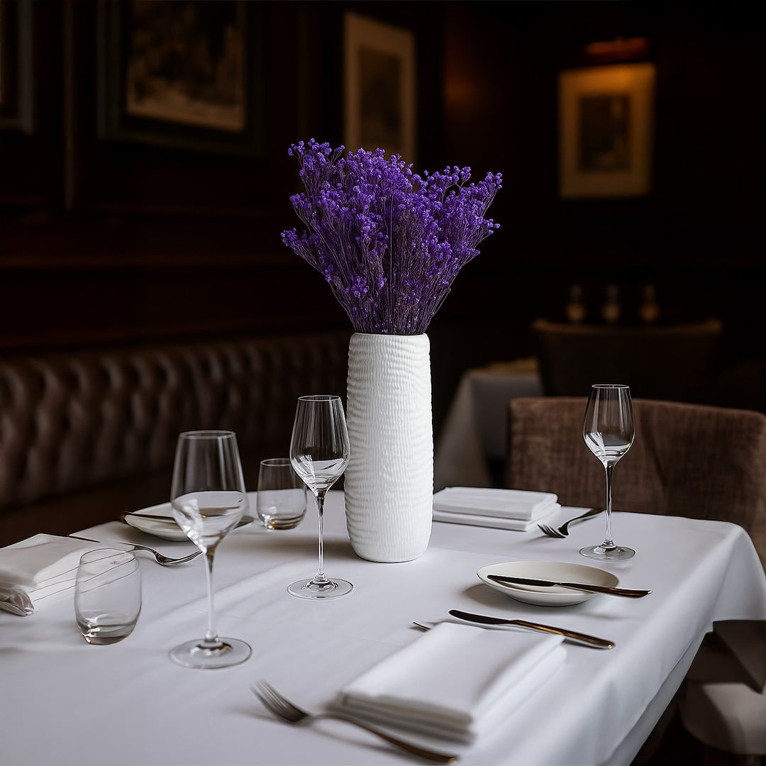 Purple dried gypsophila bunch held by hand in a bright room adding vibrant natural decor to modern home interiors.