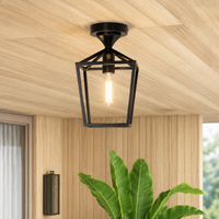 Black metal and glass outdoor hanging light for porch balcony entrance and covered patio with warm ambient lighting.