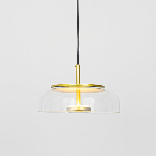 Clear glass and brass metal pendant light designed for elegant dining room and kitchen interiors.