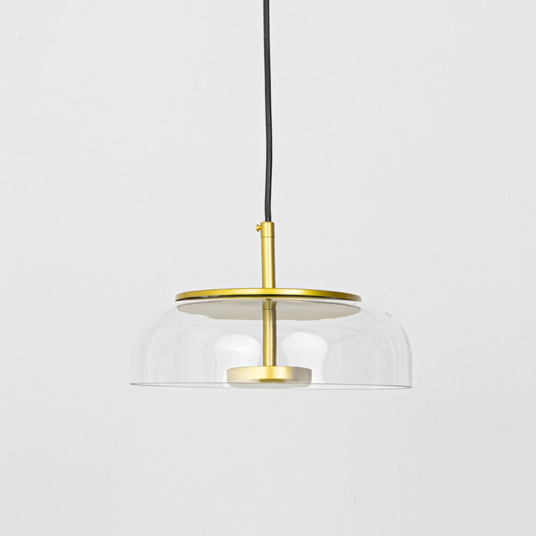 Minimalist clear glass and brass metal pendant light for refined modern home decor spaces.
