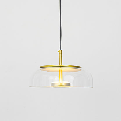 Clear glass and brass metal pendant light designed for elegant dining room and kitchen interiors.