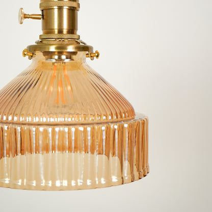Amber ribbed glass pendant light closeup highlighting textured glass detailing and premium lighting craftsmanship quality.
