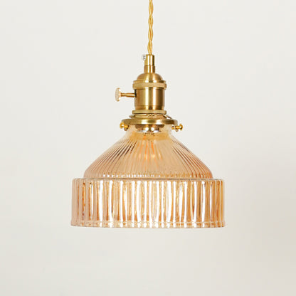 Amber ribbed glass pendant light illuminated to display luxury ceiling lighting with warm ambient decorative appeal.
