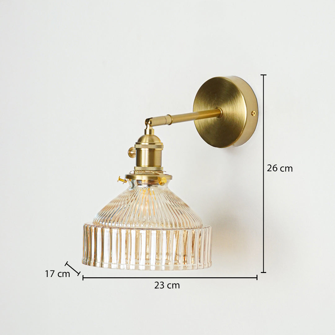 Gold metal wall light with ribbed glass shade sized 26 cm height 23 cm width and 17 cm depth ideal for wall decor installation.
