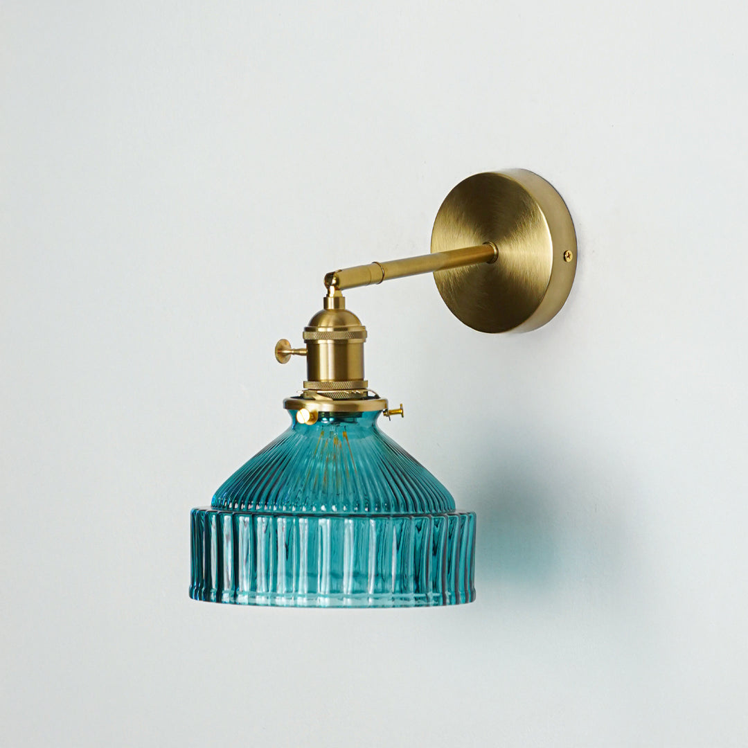 Gold metal wall light with blue ribbed glass shade and classic arm design perfect for modern interior wall decor on clean background.