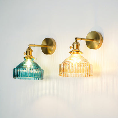 Gold finish wall lights with ribbed glass shades emitting warm ambient glow ideal for elegant interior wall decor styling.