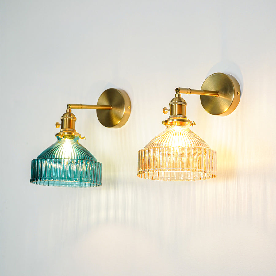 Gold finish wall lights with ribbed glass shades emitting warm ambient glow perfect for elegant interior wall decor placement.