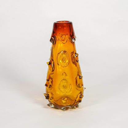 Amber decorative art glass vase on white background modern home decor accent piece for table shelf console styling interior.