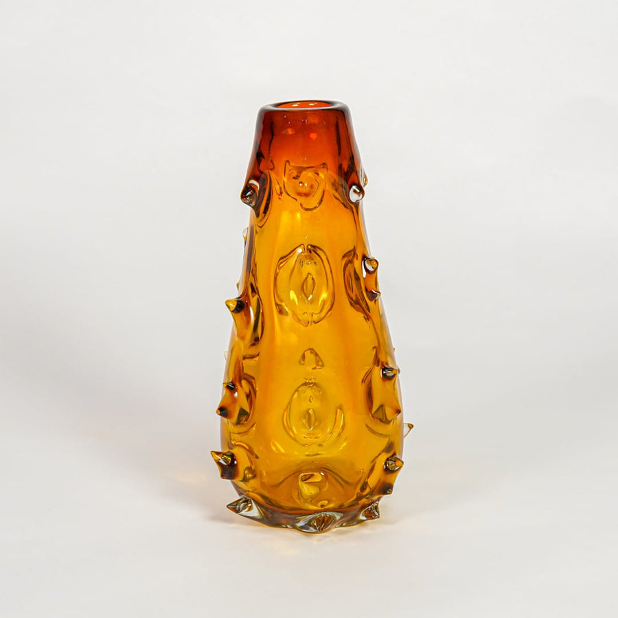 Amber decorative art glass vase on white background modern home decor accent piece for table shelf console styling interior.