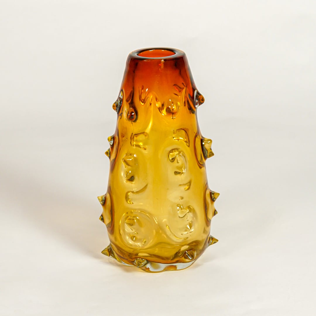 Amber decorative art glass vase on white background modern home decor accent piece for table shelf console styling interior.