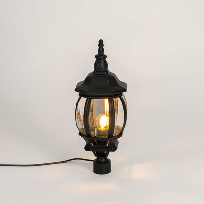Decorative black outdoor gate light with warm glowing bulb for luxury exterior decor styling use.