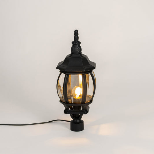 Decorative black outdoor gate light with warm glowing bulb for luxury exterior decor styling use.