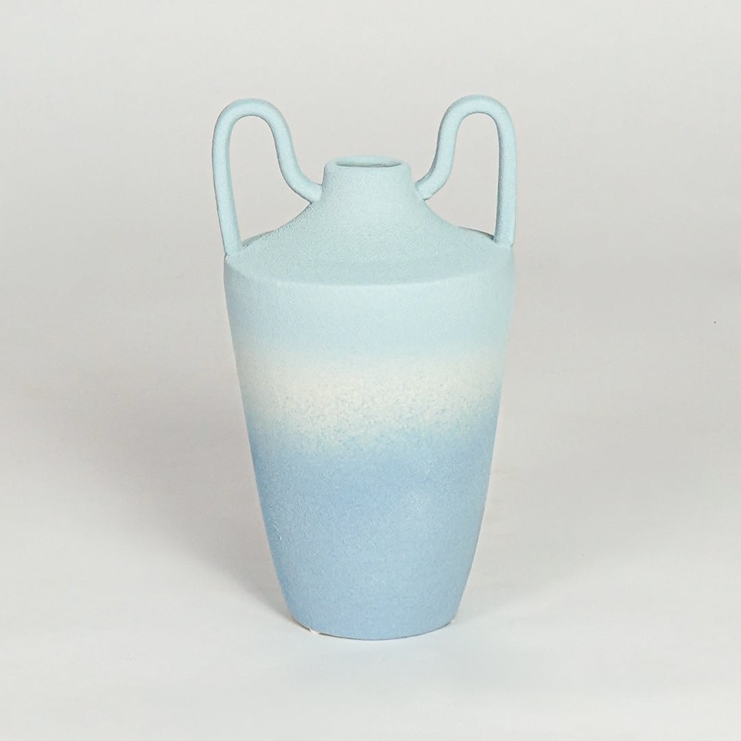 Modern light blue ceramic decorative vase with elegant curved handles and tapered silhouette for home styling.