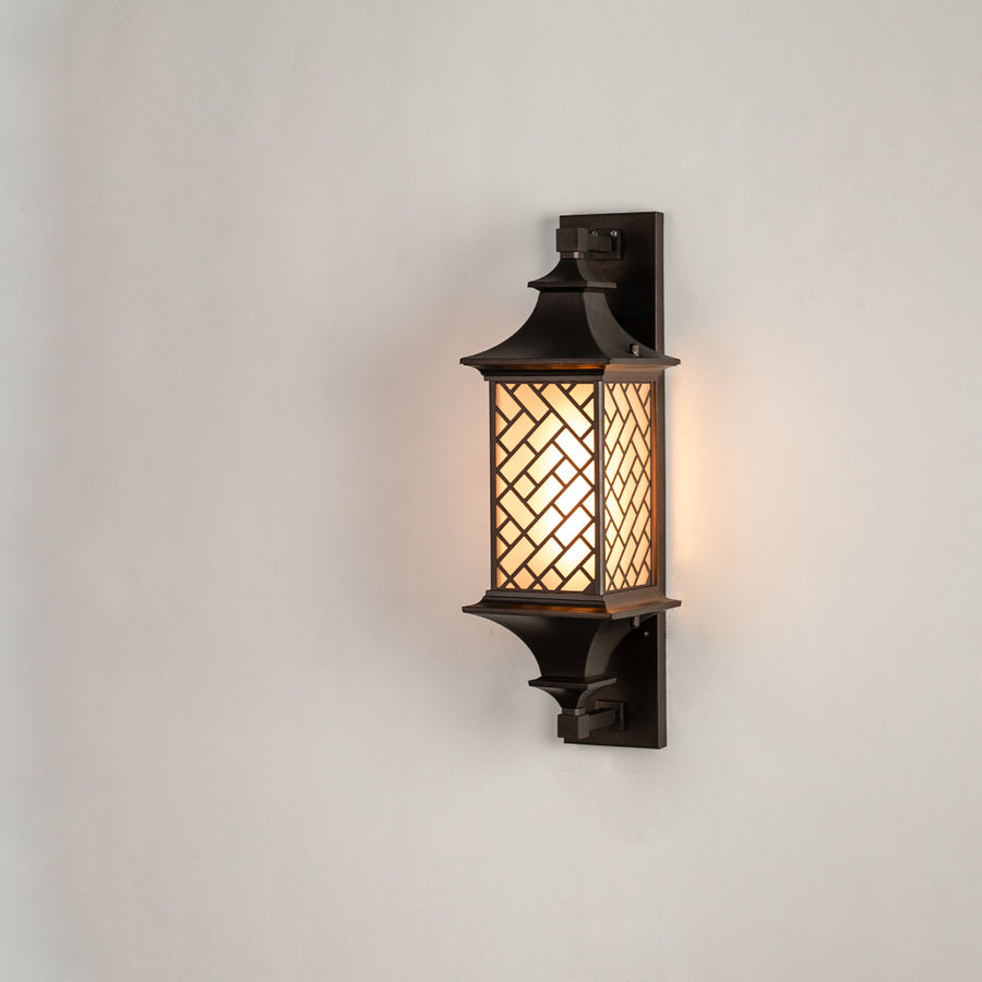 Modern bronze outdoor column wall light on white background featuring an intricate basketweave lattice overlay shade.