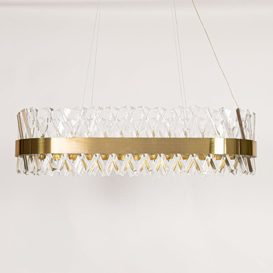 Gold metal chandelier with faceted crystal rods displayed with lights off on a clean white background showcasing its modern oval frame.