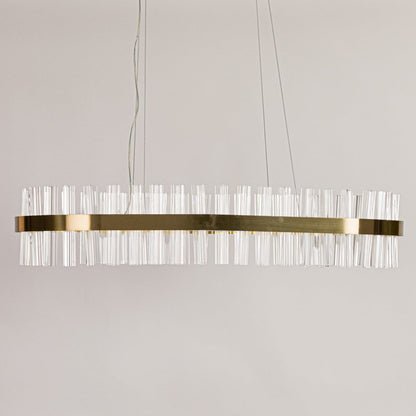 Gold metal chandelier with clear crystal rods displayed with lights off on a clean white background showcasing its sleek elongated shape.