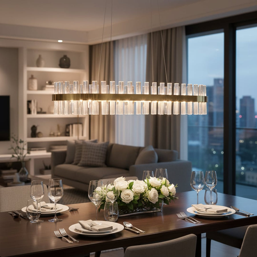 Gold metal chandelier with clear crystal rods glowing above a modern dining table creating a luxurious warm and elegant atmosphere in a contemporary home interior.