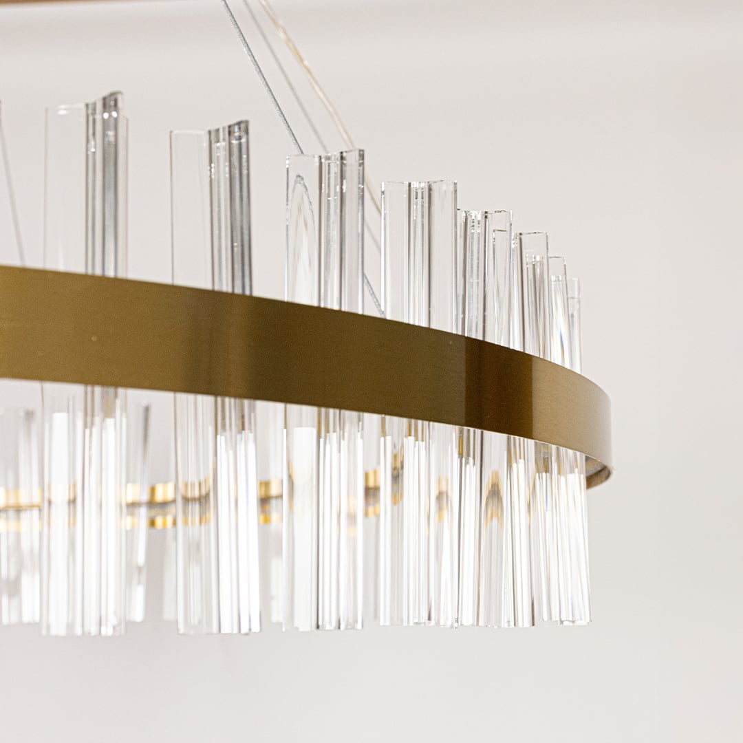 Detailed closeup of gold metal chandelier showing the crystal rod texture and polished gold frame ideal for luxurious home decor lighting.