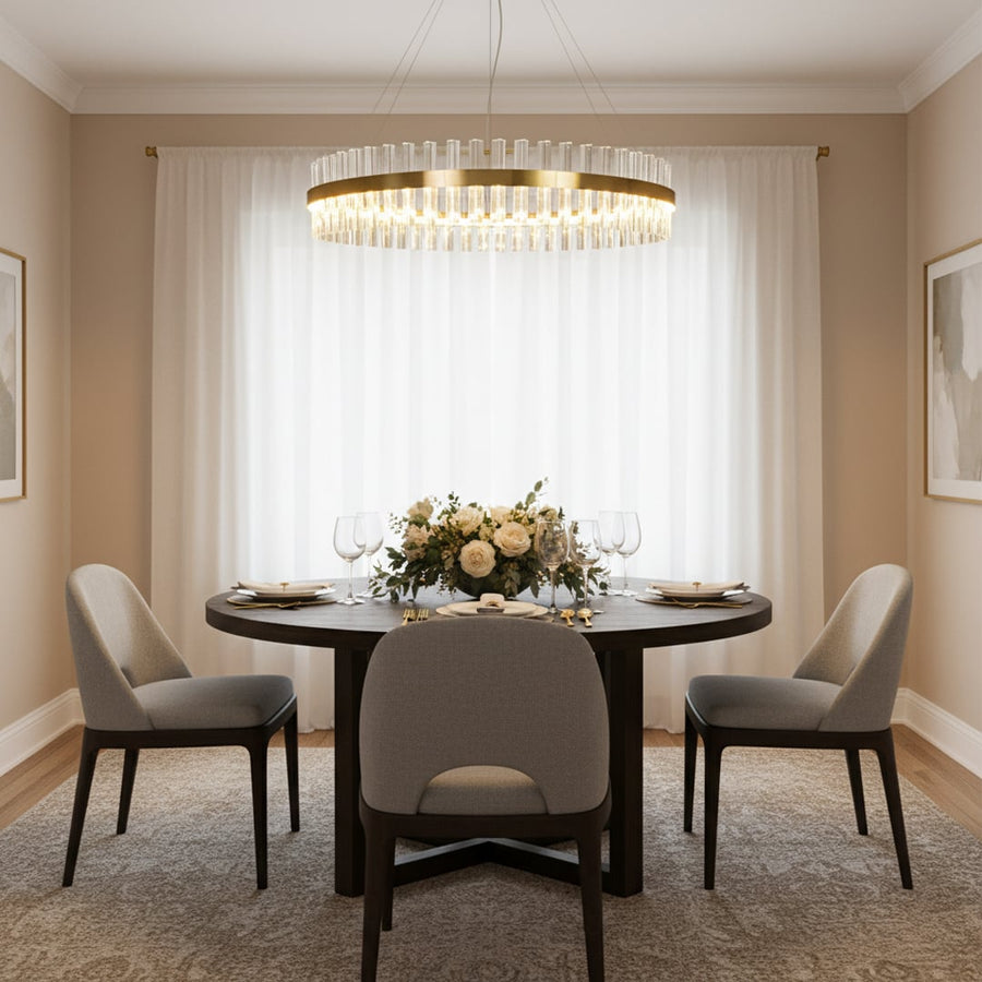Gold metal chandelier with clear crystal rods glowing above a round dining table creating an elegant luxurious and softly lit modern interior atmosphere.