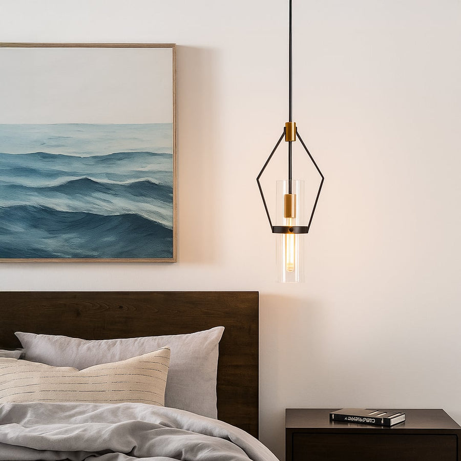 Sleek black and gold pendant light styled in a modern room creating focused warm lighting with clear glass detail.