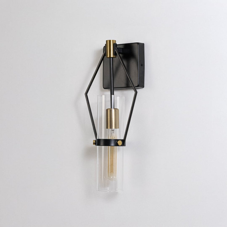 Black metal and gold wall sconce with clear glass shade shown on a white background for detailed product clarity.