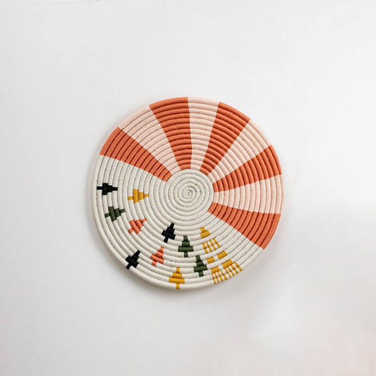 Round handcrafted multicolor seagrass wall basket for living room hallway and boho décor on white background image.