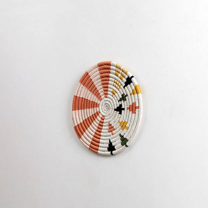 Round handcrafted seagrass wall basket for living room hallway and boho wall décor on white background image.