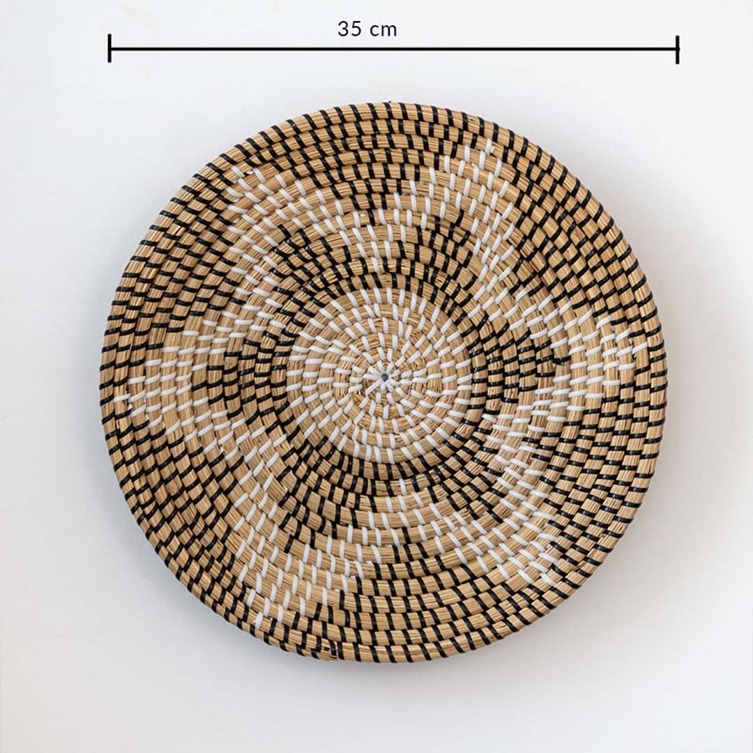 Handwoven wicker basket wall decor in beige with black and white starburst design showing 35 cm size measurement.