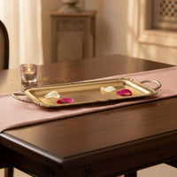 Gold metal serving tray lifestyle image with floral accents for elegant luxury dining table presentation decor.