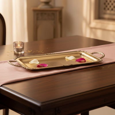 Gold metal serving tray lifestyle image with floral accents for elegant luxury dining table presentation decor.